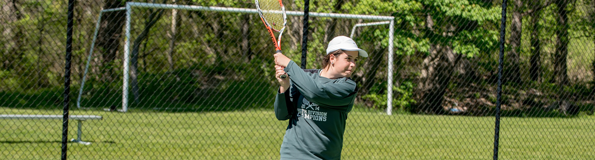 student playing tennis